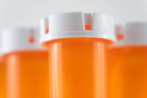 a group of empty pill bottles to show what are opioids