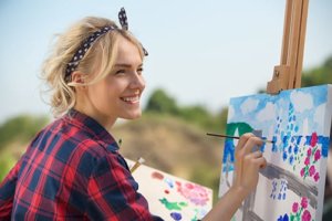A teenage girl paints during art therapy in Los Angeles CA