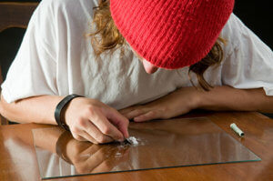 A teen sets up a line of coke and is in need of cocaine addiction treatment in Los Angeles CA