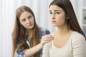A teen girl visits her teen sister at a teen bipolar disorder treatment program