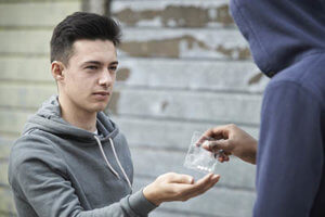 male teen buying drugs soon to experience vicodin withdrawal symptoms
